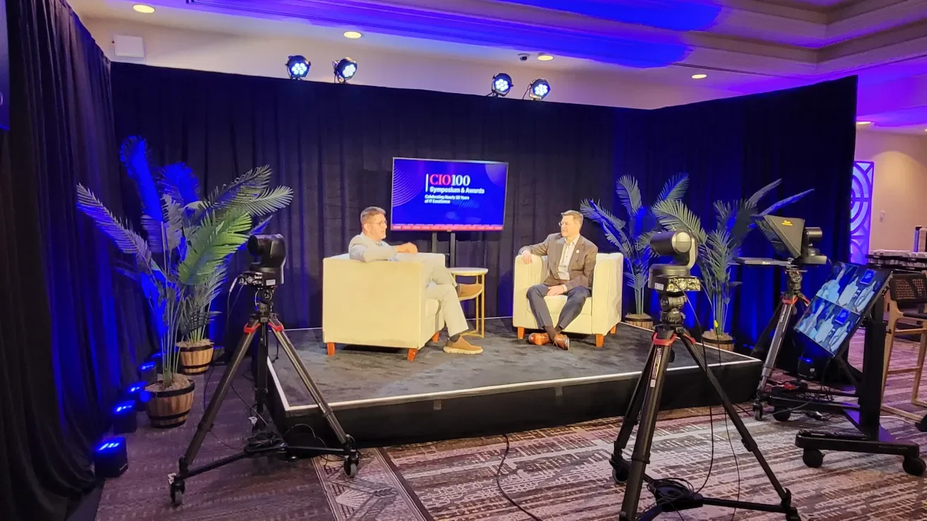 Phil and host sitting on stage