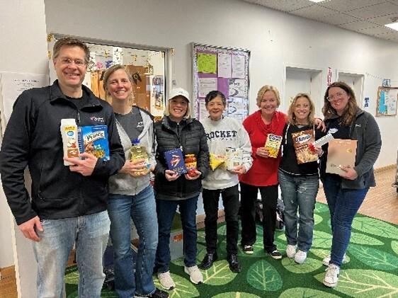 a group of people with various food items